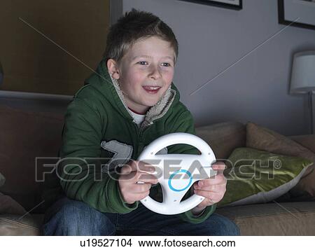 Boy, 11 playing driving game View Large Photo Image Picture - Boy, 11 playing driving game. Fotosearch