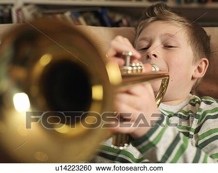 Boy, 11 playing trumpet View Large Photo Image Stock Image - Boy, 11 playing trumpet. Fotosearch