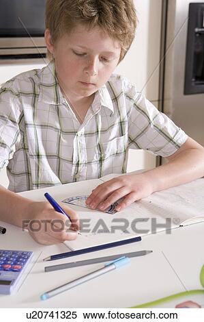 Boy 11, studying at home View Large Photo Image Stock Photography - Boy 11, studying at home. Fotosearch