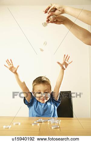 Stock Image - boy and falling coins. Fotosearch