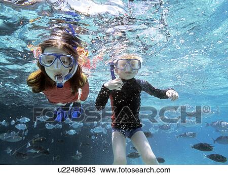 Boy and girl snorkeling View Large Photo Image Stock Image - Boy and girl snorkeling. Fotosearch