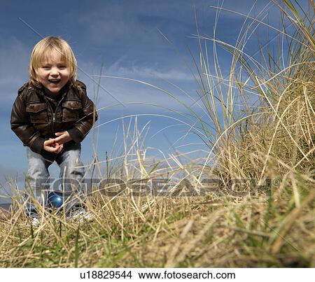 boy at beach playing with ball View Large Photo Image Picture - boy at beach playing with ball. Fotosearch
