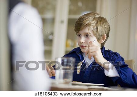 boy at table eating View Large Photo Image Stock Image - boy at table eating. Fotosearch