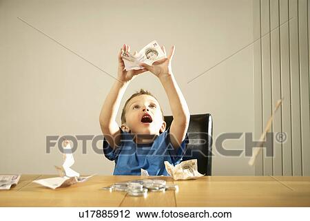 Stock Image - boy catching money. Fotosearch