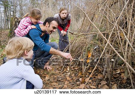 boy, girls, man lighting bonfire View Large Photo Image Stock Photo - boy, girls, man lighting bonfire. Fotosearch