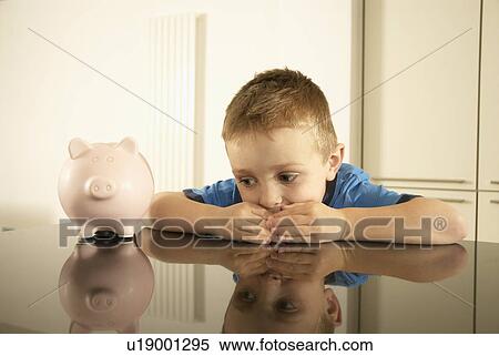 boy hoarding money View Large Photo Image Stock Photography - boy hoarding money. Fotosearch