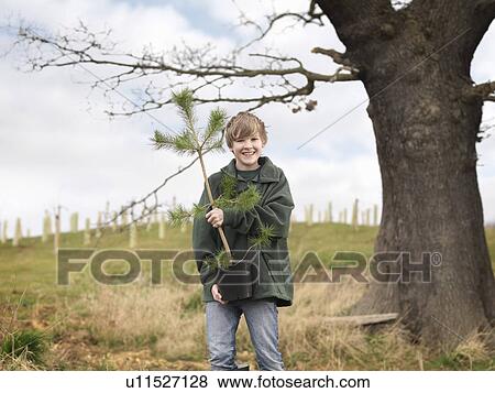 Stock Photo - Boy Holding Young Tree. Fotosearch
