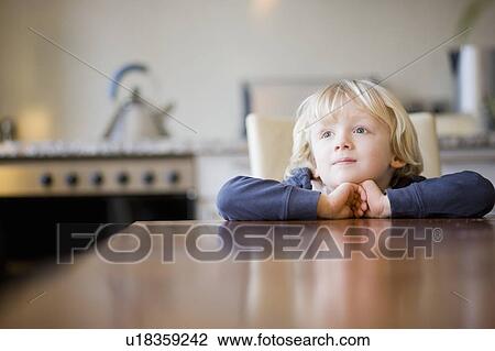 boy looking over table edge View Large Photo Image Stock Image - boy looking over table edge. Fotosearch