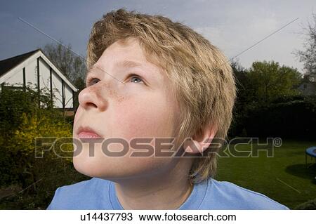 Stock Image - Boy looking up. Fotosearch