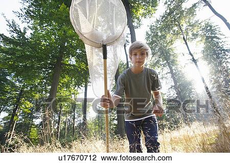 Stock Image - Boy with butterfly net. Fotosearch