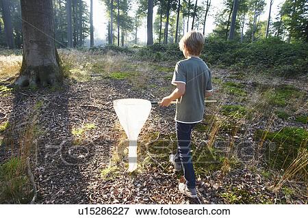 Stock Photo - Boy with butterfly net. Fotosearch