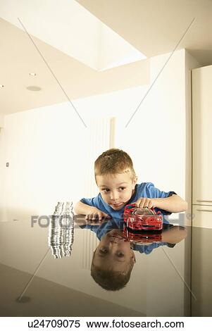 Stock Photography - boy with car and money. Fotosearch