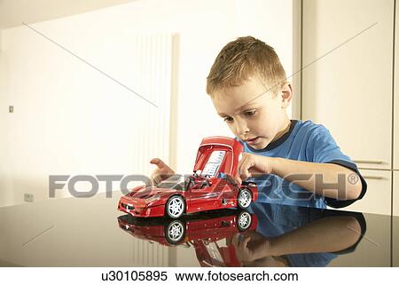 Stock Photography - boy with car. Fotosearch