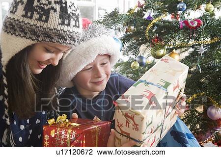 Brother and sister holding presents View Large Photo Image Stock Image - Brother and sister holding presents. Fotosearch