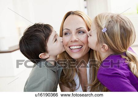 Stock Photograph - brother and sister kissing her mother. Fotosearch