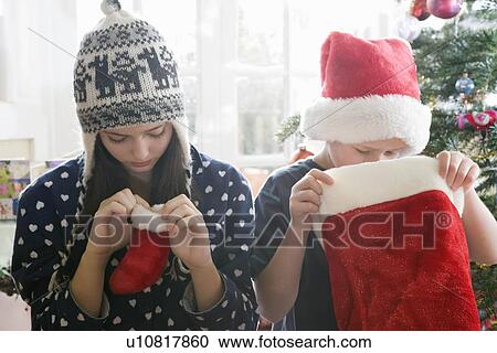 Stock Image - Brother and sister with stockings. Fotosearch