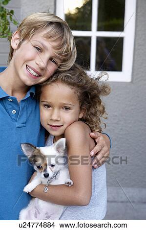Brother and sister with their dog View Large Photo Image Picture - Brother and sister with their dog. Fotosearch