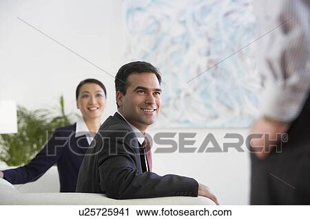 Business colleagues in a lobby area View Large Photo Image Stock Image - Business colleagues in a lobby area. Fotosearch