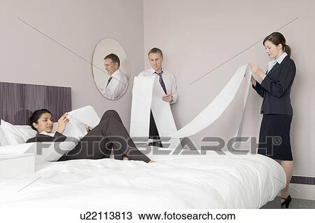 Business colleagues read computer paper View Large Photo Image Stock Image - Business colleagues read computer paper. Fotosearch