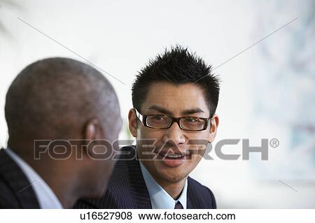 Business colleagues talk in a lobby View Large Photo Image Stock Photo - Business colleagues talk in a lobby. Fotosearch
