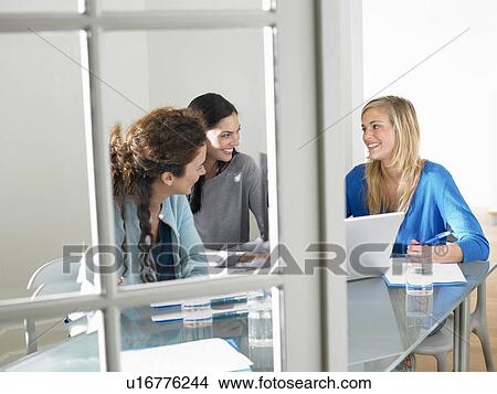 Picture - Business women working, smiling. Fotosearch