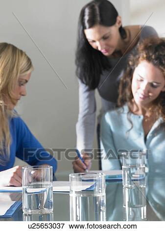 Stock Photo - Business women working, smiling. Fotosearch