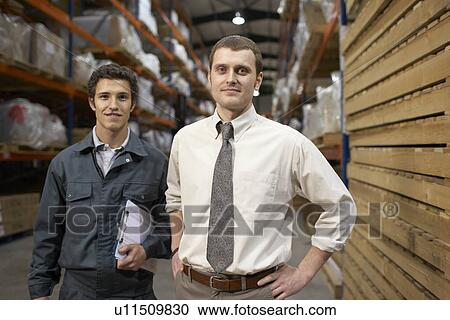 Businessman and worker in warehouse View Large Photo Image Stock Image - Businessman and worker in warehouse. Fotosearch