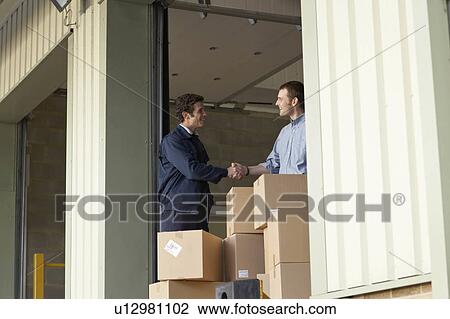 Businessman and worker in warehouse View Large Photo Image Stock Image - Businessman and worker in warehouse. Fotosearch