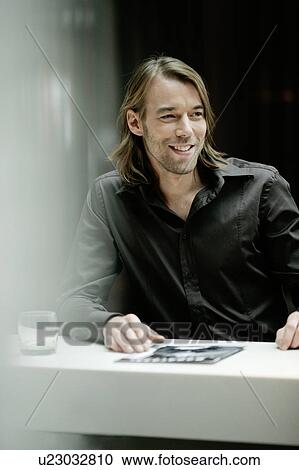 Stock Image - Businessman in bar. Fotosearch