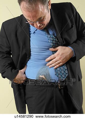 Businessman looking at hole in shirt View Large Photo Image Stock Image - Businessman looking at hole in shirt. Fotosearch