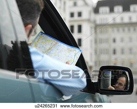 Businessman map reading in car View Large Photo Image Stock Image - Businessman map reading in car. Fotosearch