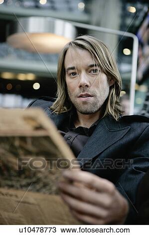 Stock Image - Businessman reading the paper. Fotosearch