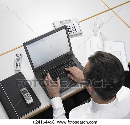 Businessman using laptop View Large Photo Image Stock Photo - Businessman using laptop. Fotosearch
