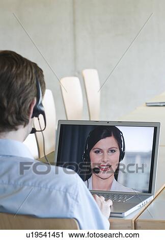 Businessman video calling colleague View Large Photo Image Stock Image - Businessman video calling colleague . Fotosearch