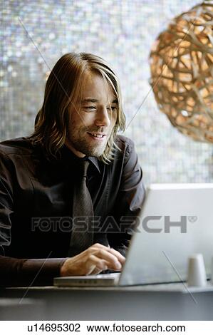 Stock Image - Businessman working on laptop. Fotosearch