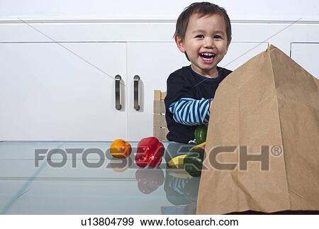 child with bag of groceries View Large Photo Image Stock Photo - child with bag of groceries. Fotosearch