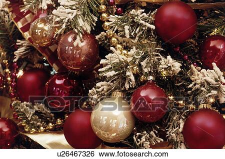 Christmas ornaments on a snowy tree View Large Photo Image Stock Photograph - Christmas ornaments on a snowy tree. Fotosearch