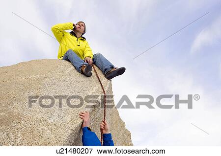 Stock Photo - Climber belaying fellow climber. Fotosearch