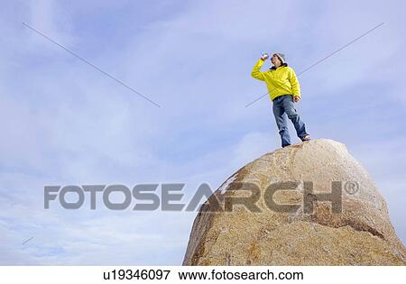 Stock Photo - Climber drinking bottle of water. Fotosearch