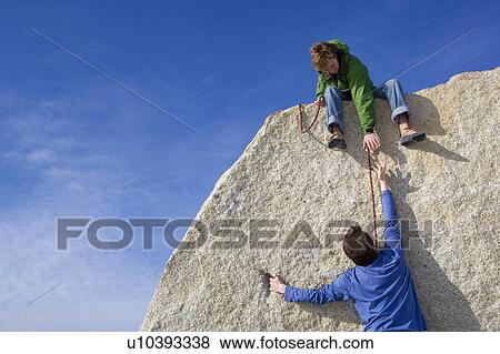 Climber helping fellow climber View Large Photo Image Stock Photo - Climber helping fellow climber. Fotosearch