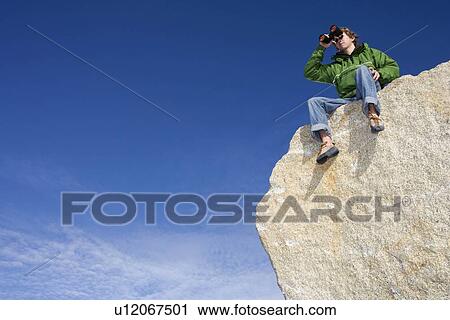 Climber looking through binoculars View Large Photo Image Stock Image - Climber looking through binoculars. Fotosearch