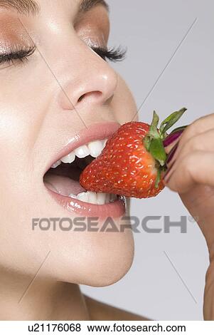 close up of female eating strawberry View Large Photo Image Stock Photo - close up of female eating strawberry. Fotosearch