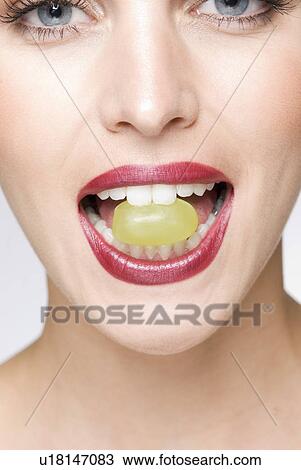 close up of female with grape in mouth View Large Photo Image Stock Image - close up of female with grape in mouth. Fotosearch