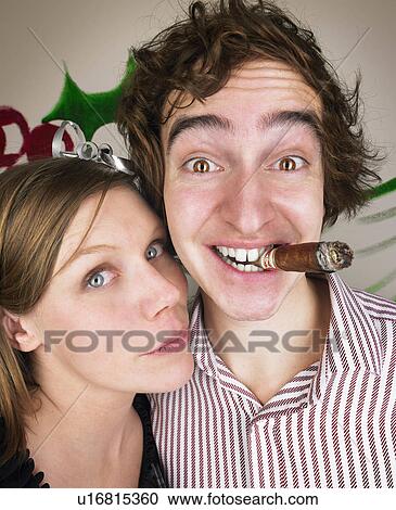 Stock Image - Couple at christmas party. Fotosearch