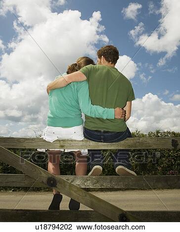 Couple Cuddling on gate View Large Photo Image Stock Image - Couple Cuddling on gate. Fotosearch