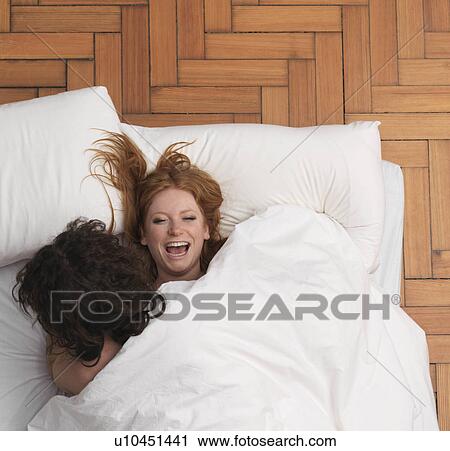 Couple fooling around in bed View Large Photo Image Stock Image - Couple fooling around in bed. Fotosearch