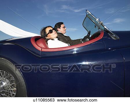 Couple in an old convertible View Large Photo Image Stock Image - Couple in an old convertible. Fotosearch