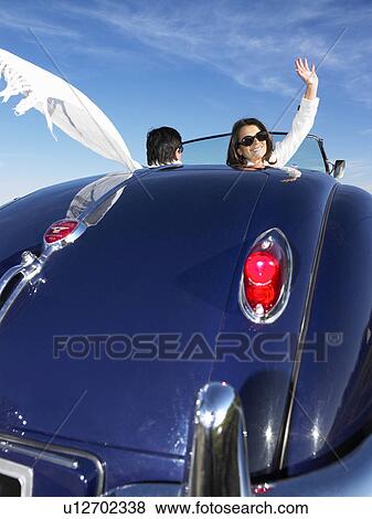 Couple in an old convertible View Large Photo Image Stock Photo - Couple in an old convertible. Fotosearch