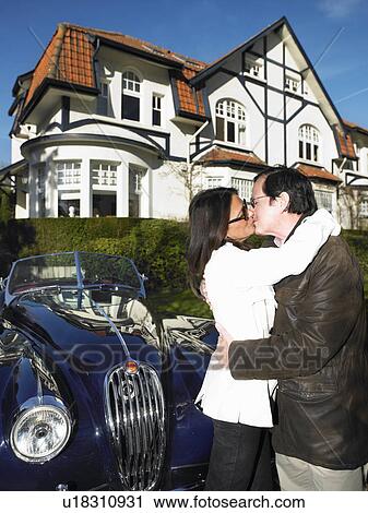 Couple in front of their house and car View Large Photo Image Stock Image - Couple in front of their house and car. Fotosearch