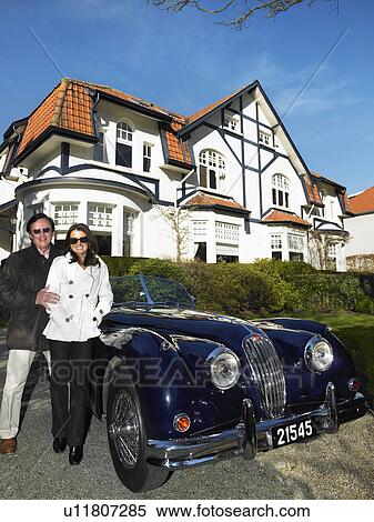 Couple in front of their house and car View Large Photo Image Stock Photography - Couple in front of their house and car. Fotosearch